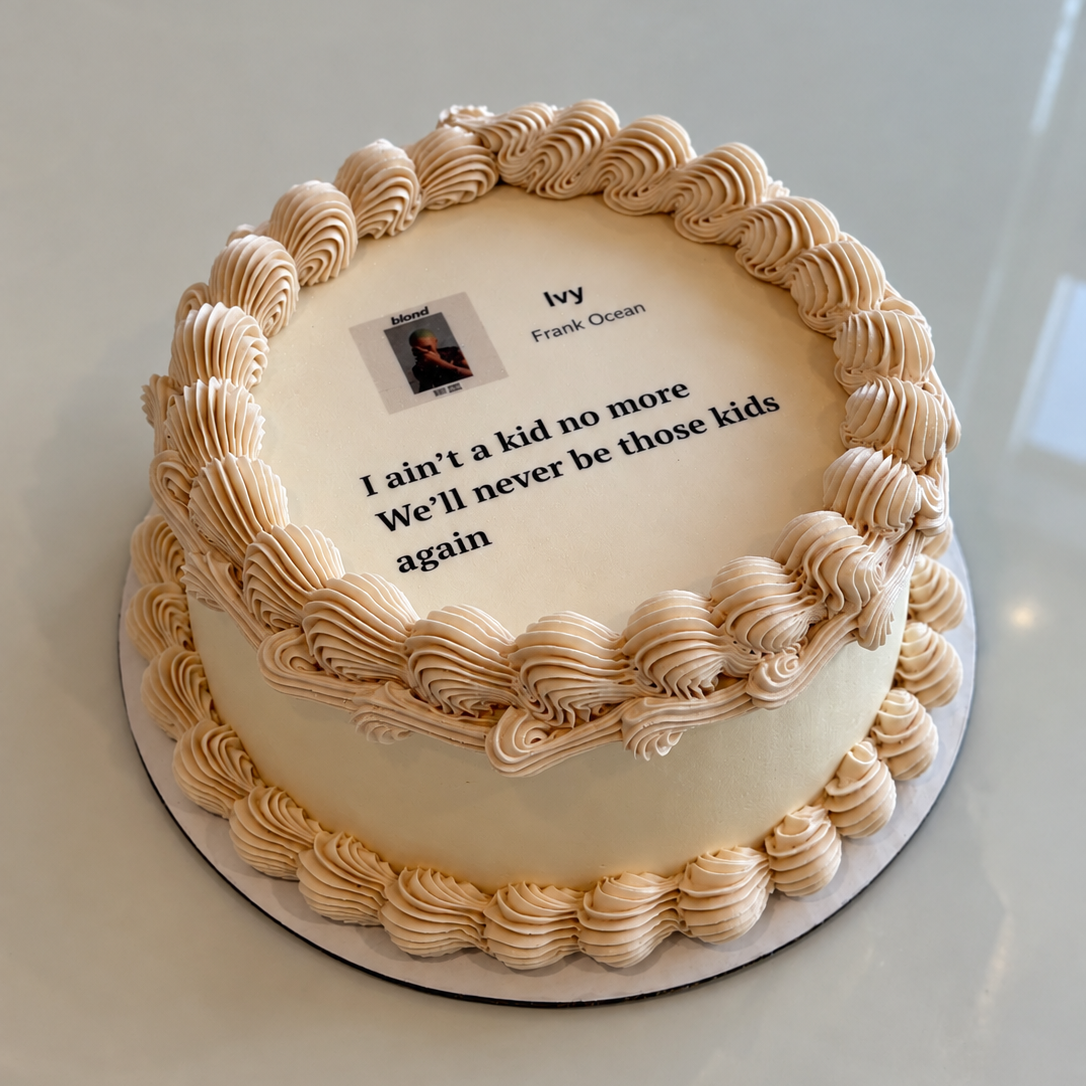 cake with tan piped borders and a printed music-player style image with lyrics