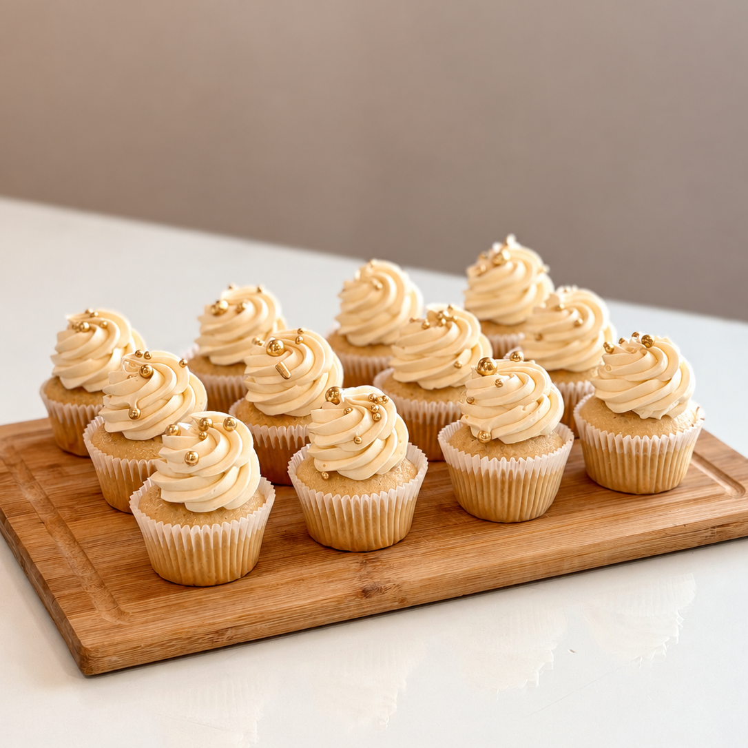 cupcakes with cream frosting swirls on a wooden board